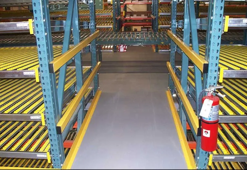 Carton flow lane detail showing roller wheel bed