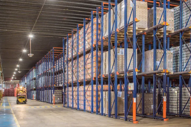 Forklift operator accessing drive-in storage system