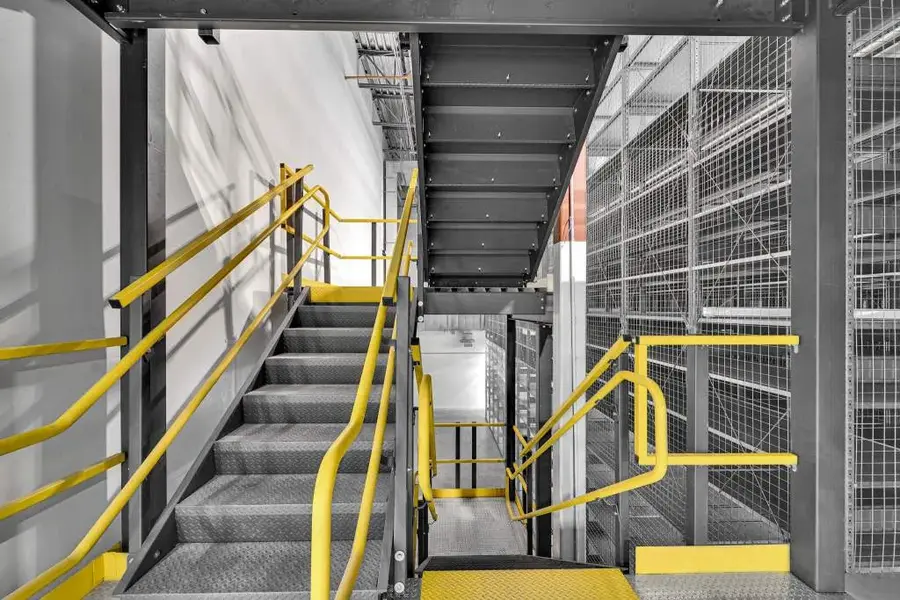 Multi-level mezzanine with staircase and safety railing
