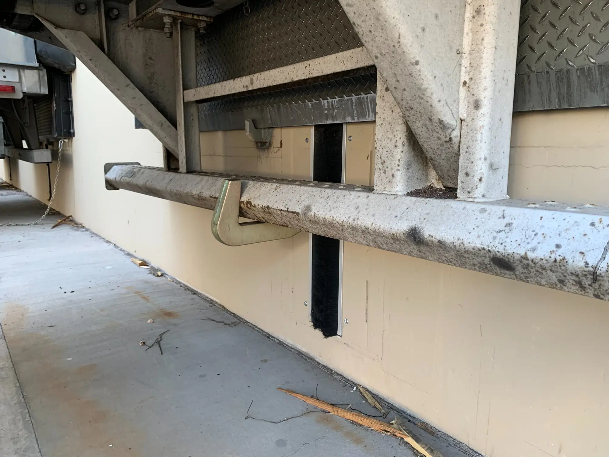 Hook-style vehicle restraint engaged on trailer ICC bar