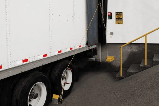 Vehicle restraint protecting dock workers during unloading