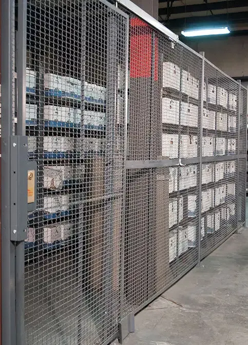 Wire partitions dividing warehouse storage zones