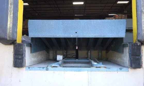 Hydraulic dock leveler with dock seals at a warehouse loading bay
